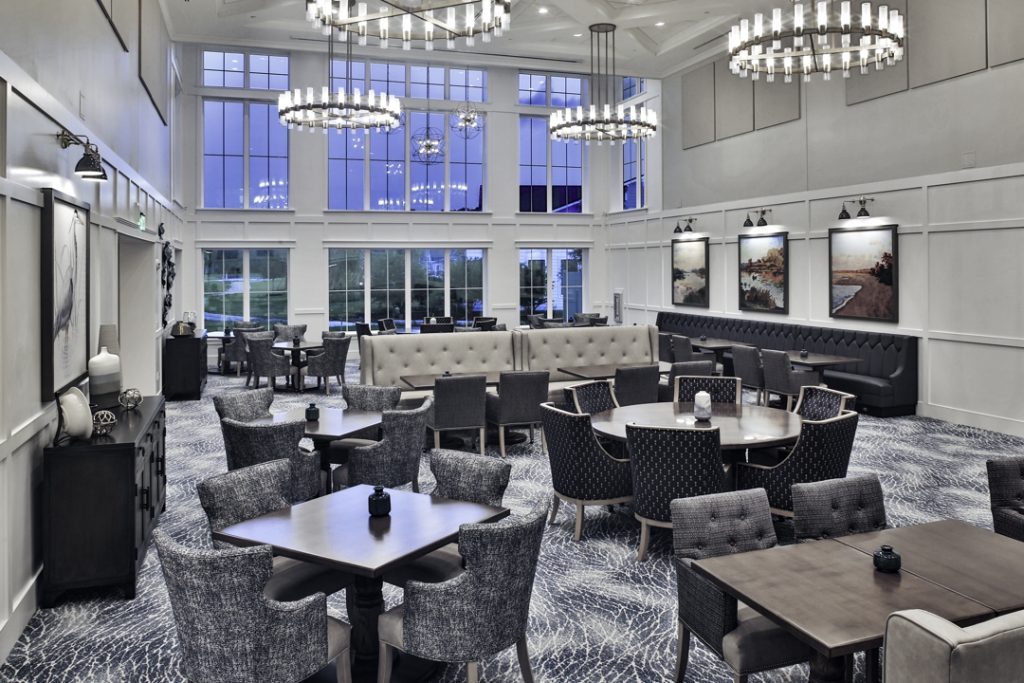 The tall-volume Oak Room, formal dining venue, features floor to ceiling windows.