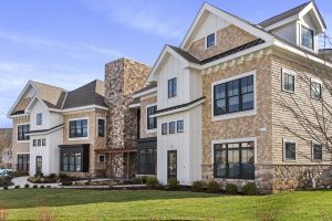 LiveWell River Homes reflect New England setting with stone and shingles