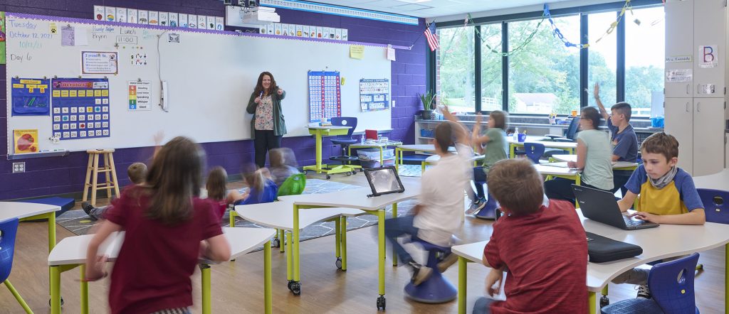 Teacher at whiteboard in front of class of elementary students