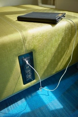 close up of a charger station in a green padded chair