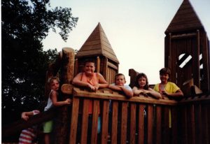 Children playing on a timber framed playground in the 1990s.