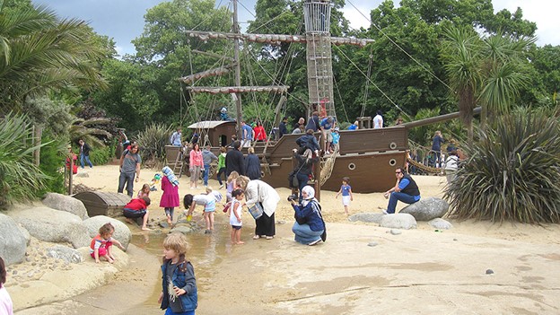 A Peter Pan themed playground with a wooden pirate ship