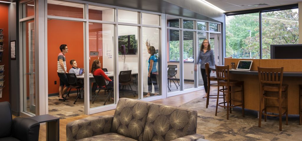 group study rooms with glass walls. students are sitting inside